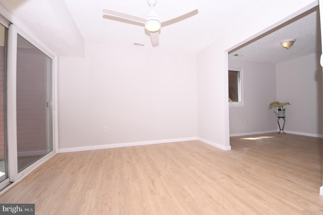 unfurnished room featuring a ceiling fan, baseboards, visible vents, and light wood-style floors