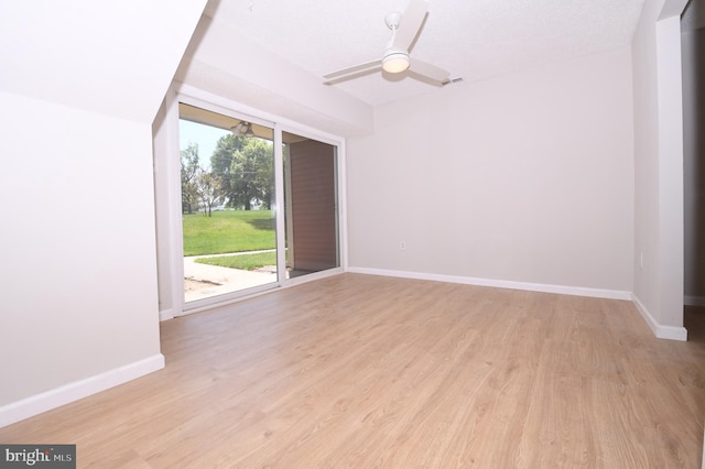 empty room with baseboards, a ceiling fan, and light wood-style floors