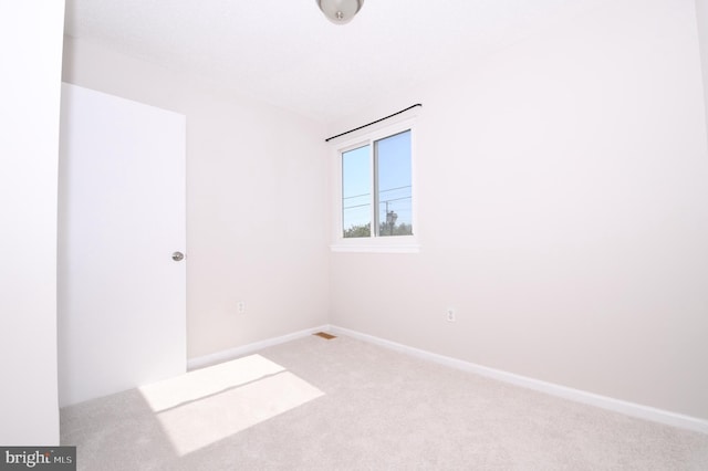 carpeted spare room with baseboards