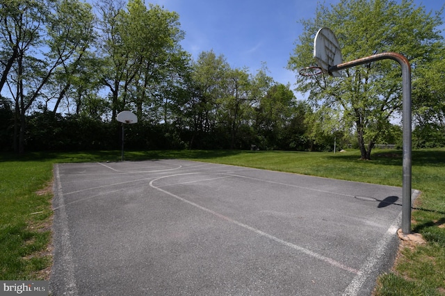 view of sport court featuring a lawn and community basketball court