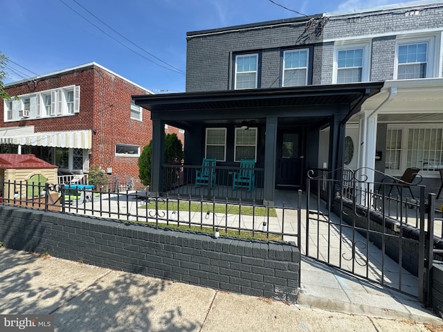 5371 Chillum Pl NE, Washington, DC 20011 - multi unit property with a porch, a fenced front yard, brick siding, and mansard roof