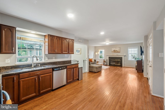 9033 Allington Manor Cir W, Frederick, MD 21703 - kitchen featuring a sink, light wood-style flooring, open floor plan, stainless steel dishwasher, and a fireplace with flush hearth