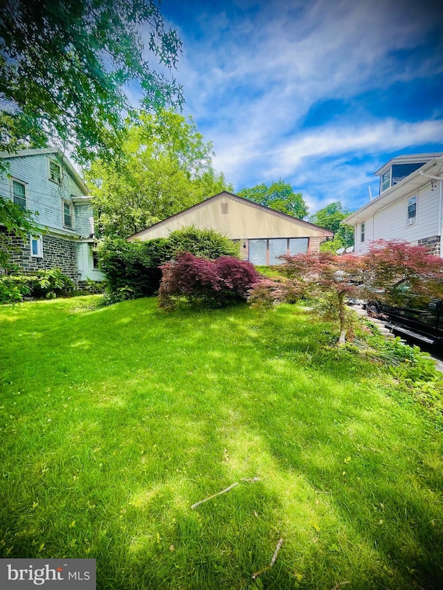 view of green lawn with an outbuilding