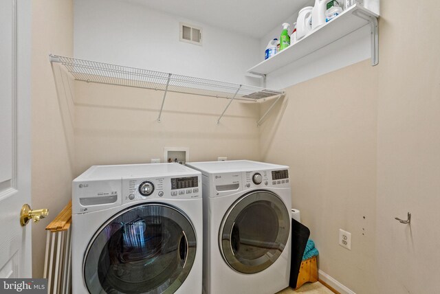 laundry room featuring independent washer and dryer, laundry area, visible vents, and baseboards