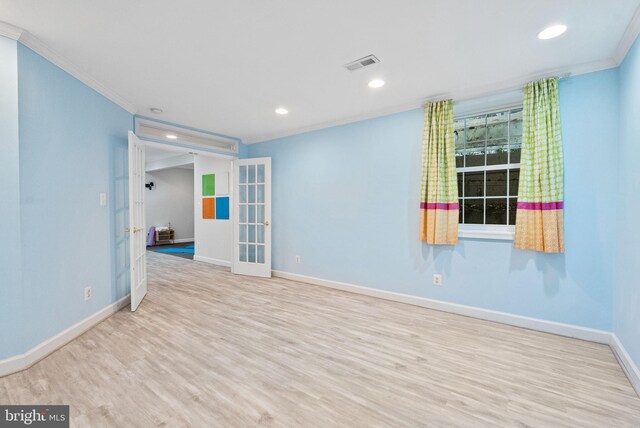 empty room with french doors, ornamental molding, baseboards, and visible vents