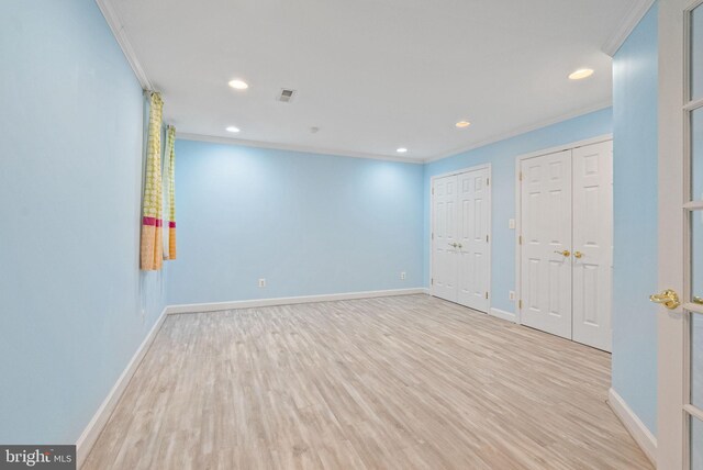 spare room featuring baseboards, ornamental molding, and wood finished floors