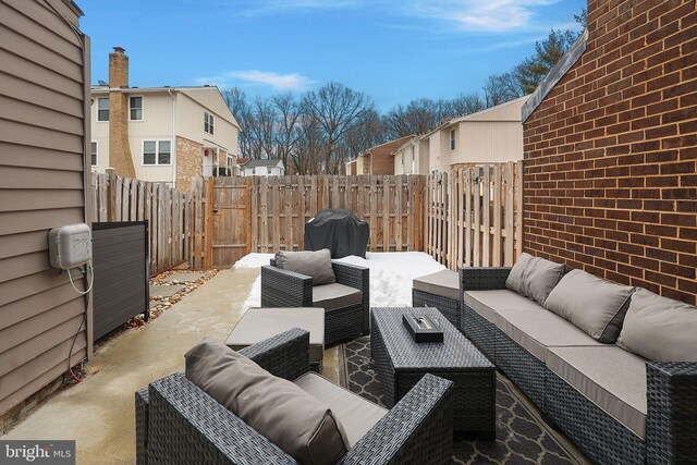 view of patio with fence, a grill, an outdoor living space, a gate, and a residential view