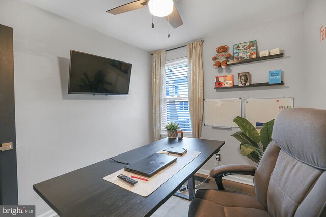 office featuring ceiling fan and baseboards