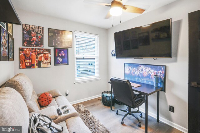 office area featuring baseboards, a ceiling fan, and wood finished floors