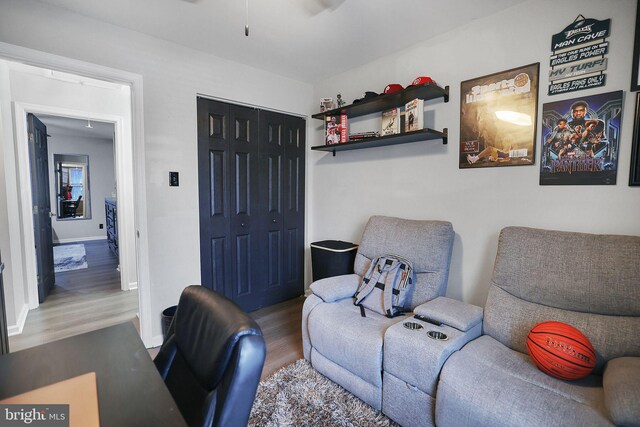 interior space with baseboards, ceiling fan, and wood finished floors