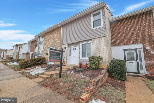 townhome / multi-family property featuring brick siding and a residential view