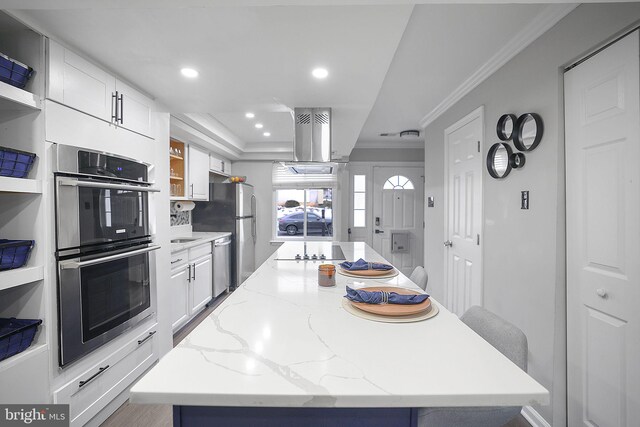 kitchen featuring a kitchen island, open shelves, stainless steel appliances, recessed lighting, and white cabinetry