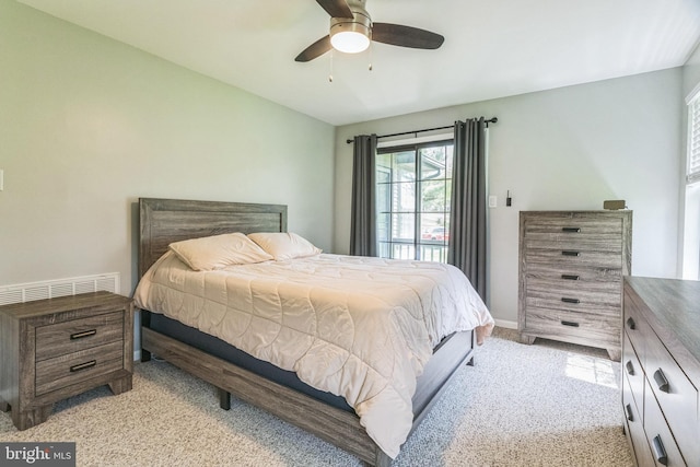 bedroom with a ceiling fan, visible vents, and light carpet