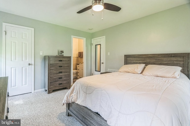 bedroom featuring carpet floors, a ceiling fan, baseboards, and ensuite bath
