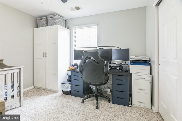 carpeted office with ceiling fan and visible vents