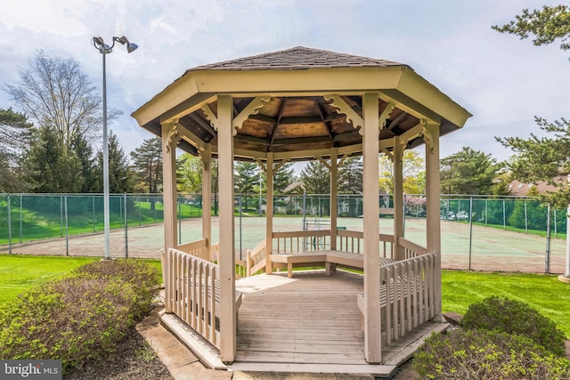 wooden deck with a gazebo and fence