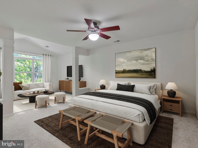 bedroom featuring ceiling fan, decorative columns, light colored carpet, visible vents, and lofted ceiling