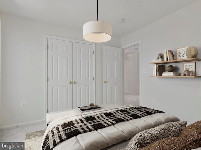 bedroom featuring a closet, carpet, and baseboards