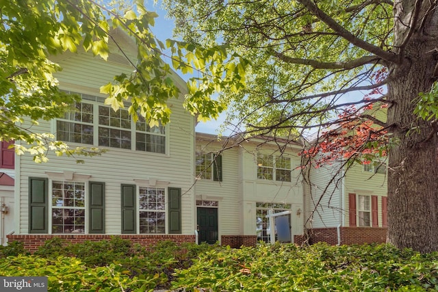 view of side of home with brick siding