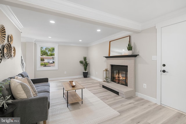 living room with a brick fireplace, recessed lighting, and wood finished floors