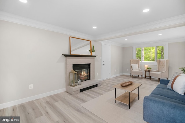 living area featuring a brick fireplace, recessed lighting, crown molding, and wood finished floors