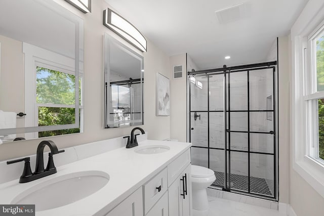 bathroom with a sink, marble finish floor, and visible vents