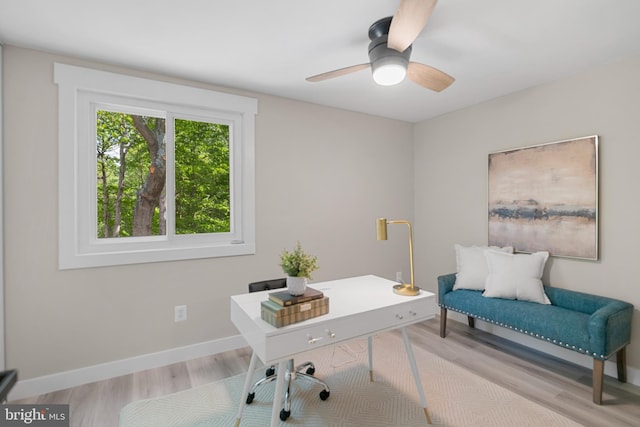 home office with light wood-style floors, baseboards, and ceiling fan