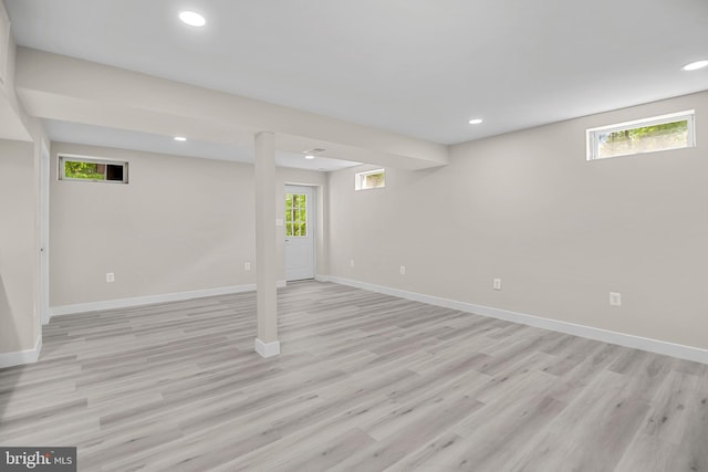 basement with recessed lighting, baseboards, and light wood-style floors