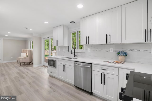 kitchen with stainless steel appliances, recessed lighting, decorative backsplash, and a sink