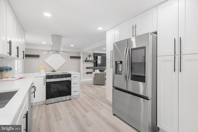 kitchen featuring appliances with stainless steel finishes, light wood finished floors, white cabinetry, and island range hood