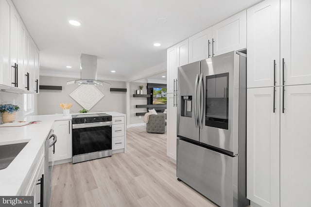 kitchen with white cabinets, stainless steel appliances, island exhaust hood, and light wood-type flooring