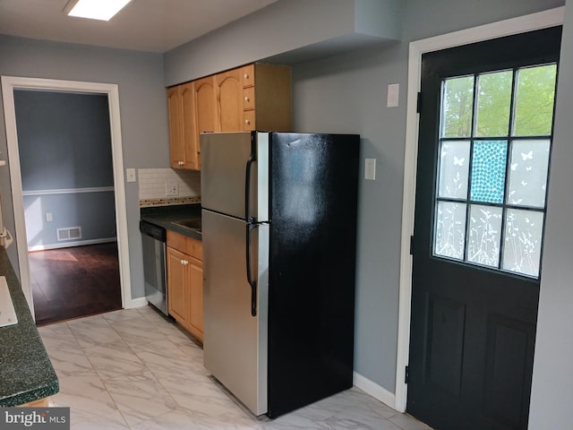kitchen with backsplash, visible vents, dark countertops, marble finish floor, and stainless steel appliances