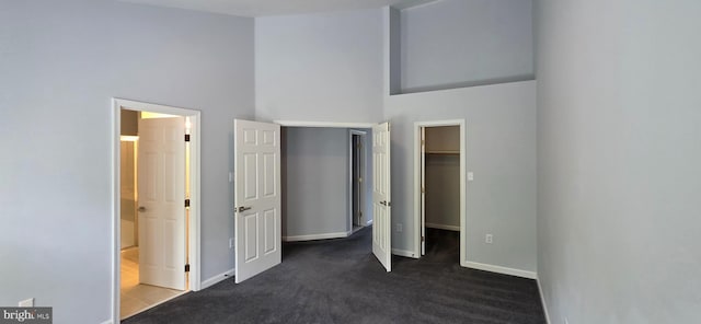 43183 Glenelder Ter, Ashburn, VA 20147 - unfurnished bedroom with a spacious closet, dark carpet, a towering ceiling, ensuite bathroom, and a closet