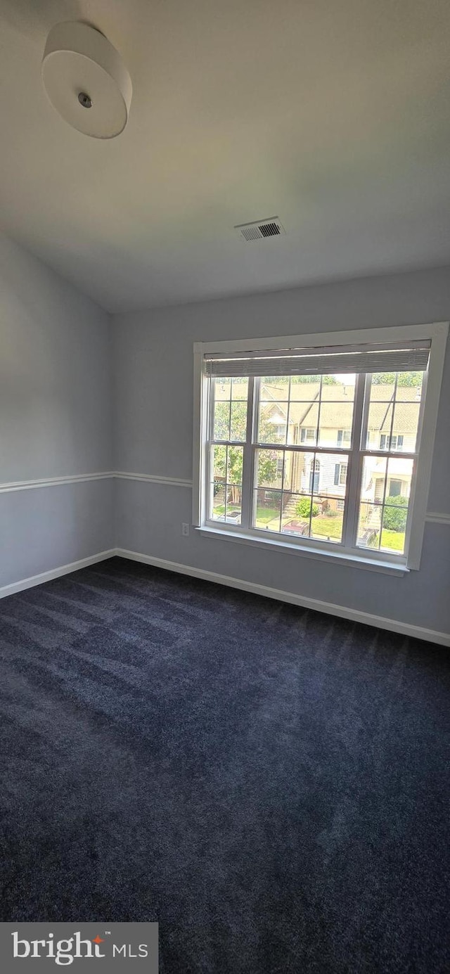 43183 Glenelder Ter, Ashburn, VA 20147 - spare room featuring dark colored carpet and plenty of natural light