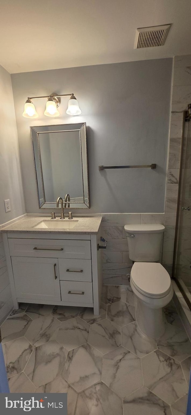 43183 Glenelder Ter, Ashburn, VA 20147 - bathroom featuring vanity, a shower stall, and marble look tile flooring