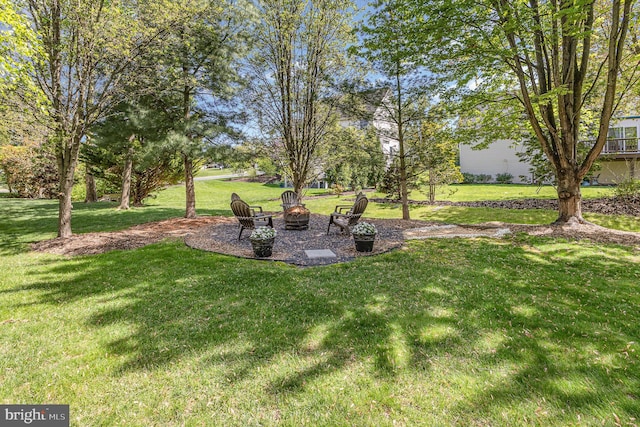 view of yard with a fire pit