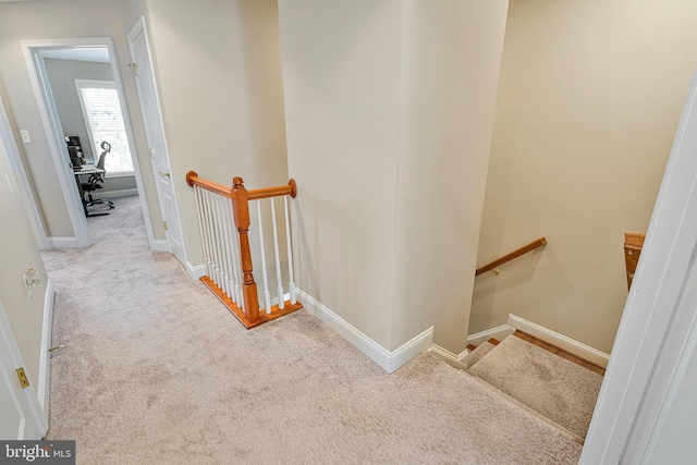 staircase with carpet floors and baseboards
