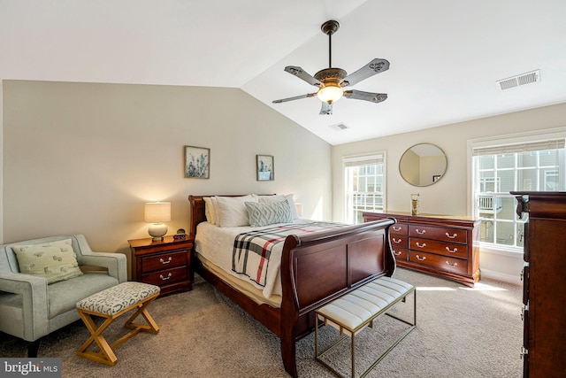 carpeted bedroom featuring a ceiling fan, visible vents, and vaulted ceiling