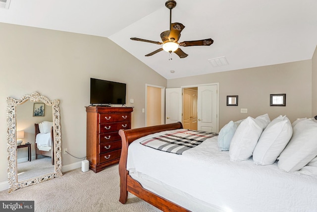 bedroom featuring light colored carpet, a ceiling fan, baseboards, lofted ceiling, and a closet