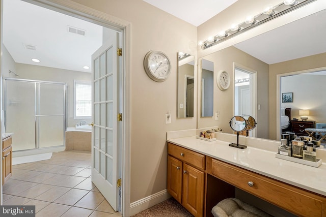 ensuite bathroom with a garden tub, visible vents, a shower stall, vanity, and tile patterned floors