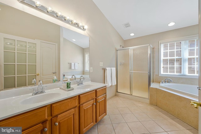 full bathroom with tile patterned flooring, a sink, a garden tub, and a stall shower