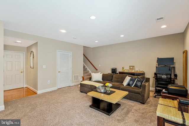 living room with stairs, recessed lighting, visible vents, and carpet