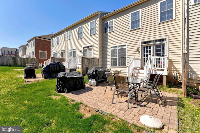back of house with a patio area and a yard