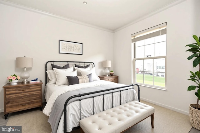 carpeted bedroom with crown molding and baseboards