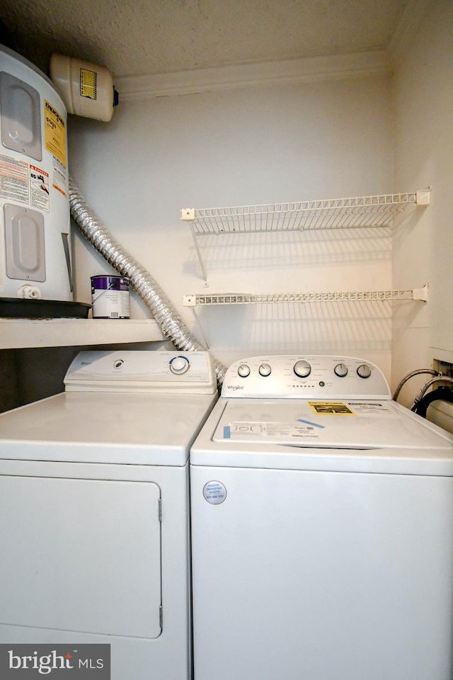 laundry area with ornamental molding, laundry area, and washer and dryer