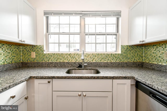 kitchen featuring a sink, decorative backsplash, white cabinets, and dishwasher