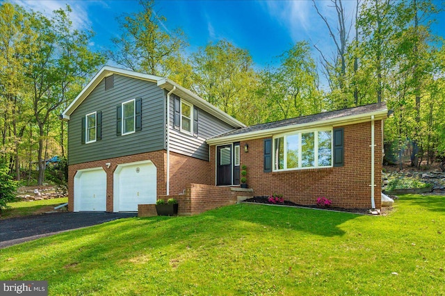 tri-level home with an attached garage, a front yard, driveway, and brick siding