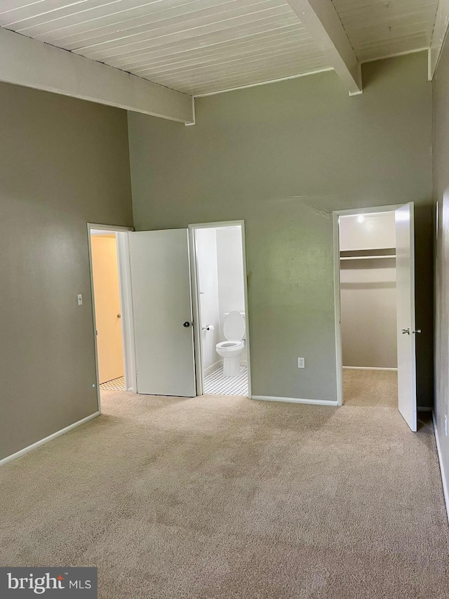 11352 Cherry Hill Rd Unit 1Y304, Beltsville, MD 20705 - unfurnished bedroom featuring a walk in closet, high vaulted ceiling, baseboards, beamed ceiling, and carpet flooring