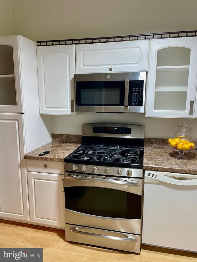 11352 Cherry Hill Rd Unit 1Y304, Beltsville, MD 20705 - kitchen featuring light wood-style flooring, white cabinetry, glass insert cabinets, and stainless steel appliances