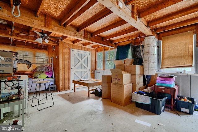misc room featuring concrete floors, ceiling fan, and a wealth of natural light